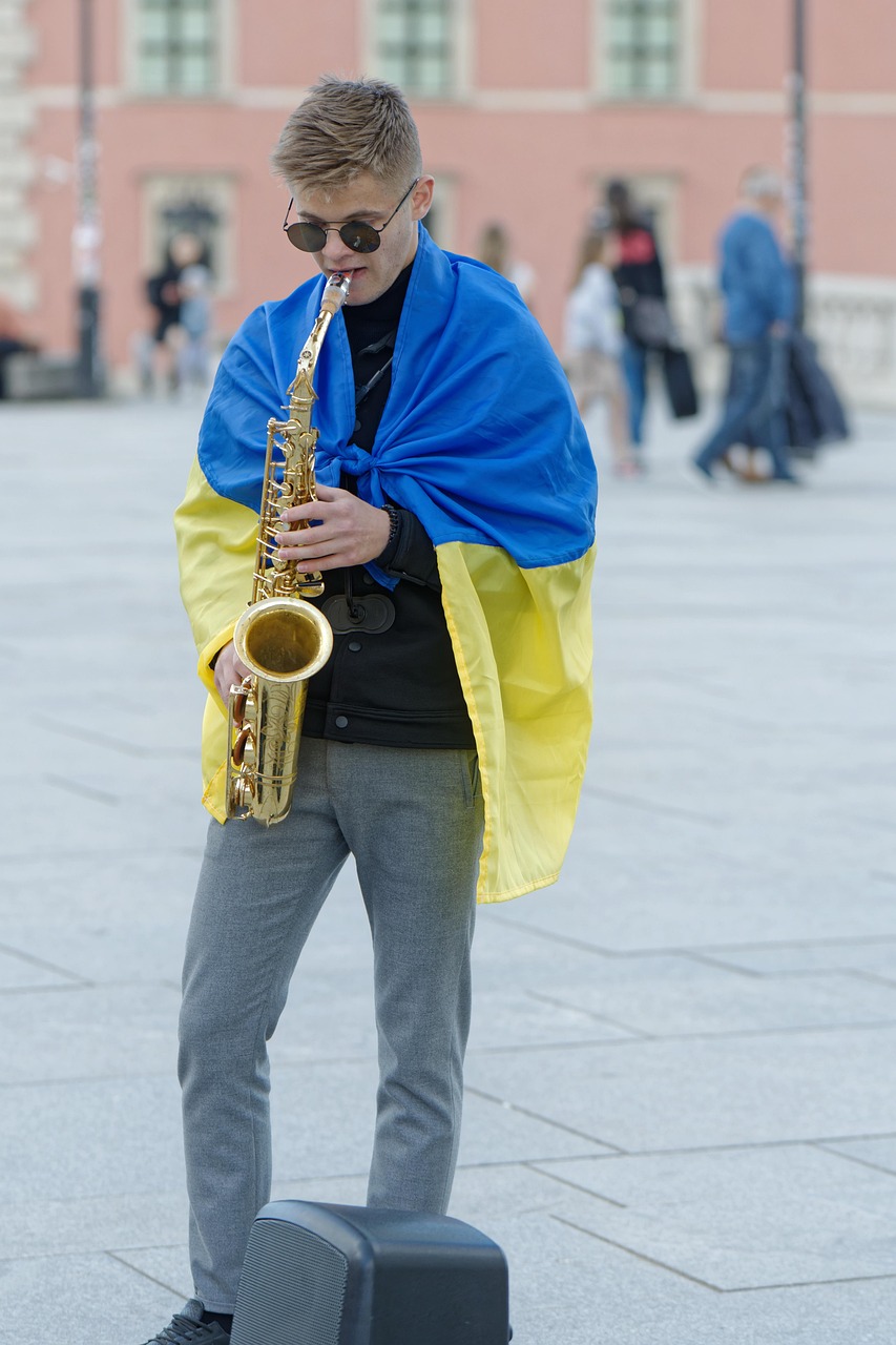 ukrainian flag, street performer, musician, busker, saxophone, city, urban, caucasian